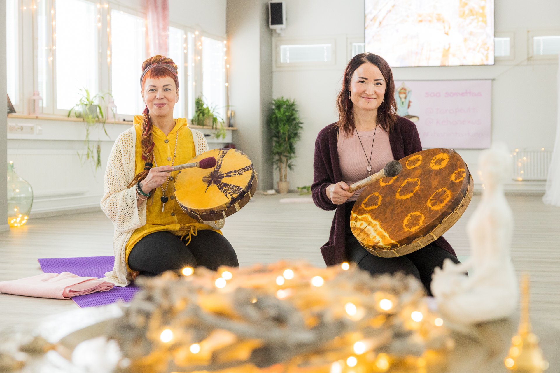 Geneesi's Taara Tuomisilta and Maiju Rissanen play shaman drums in the company's premises. | Business Joensuu, business services